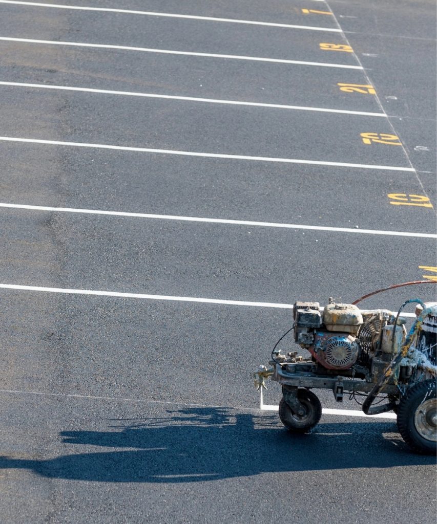 Parking lot line striping with professional striping machine