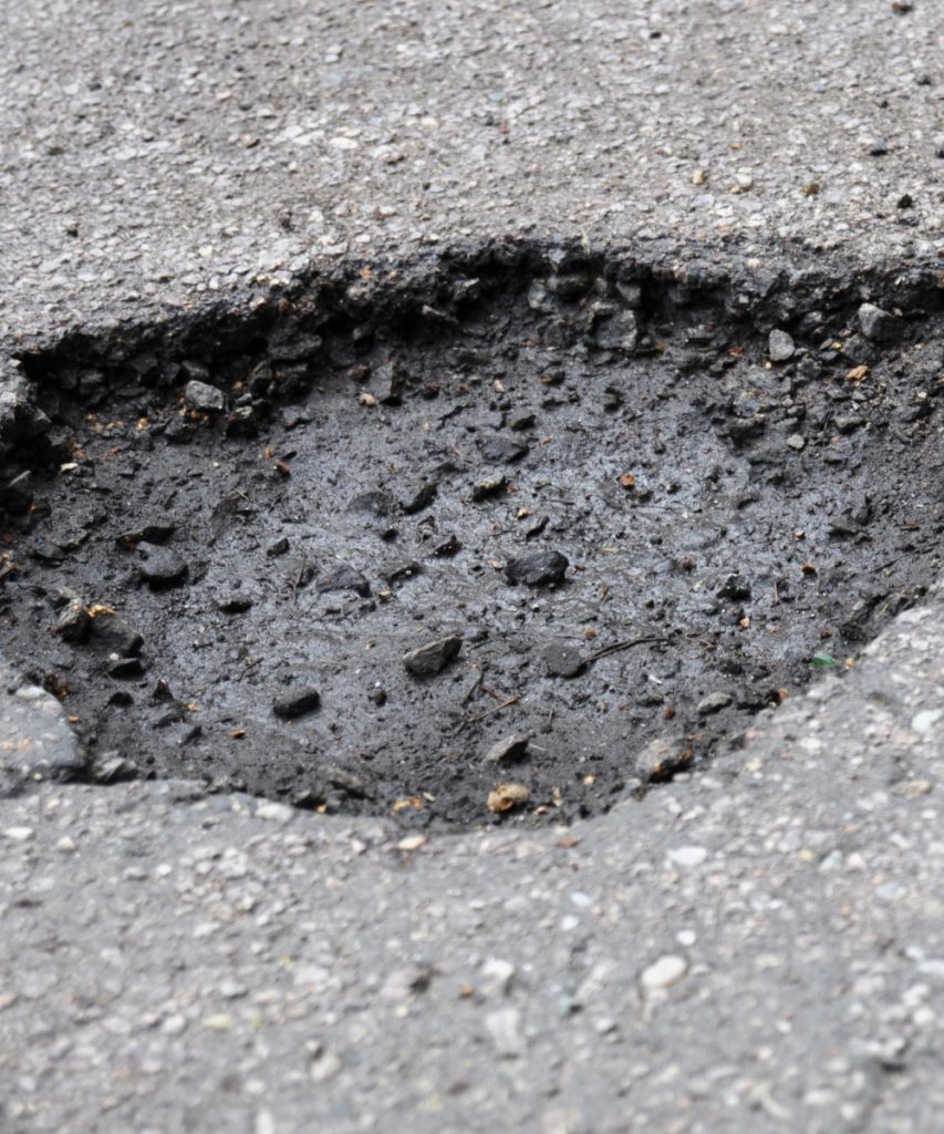 Pothole in asphalt pavement needing repair