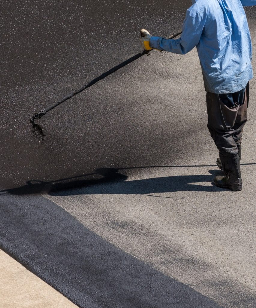 Spray sealcoating asphalt driveway for protection